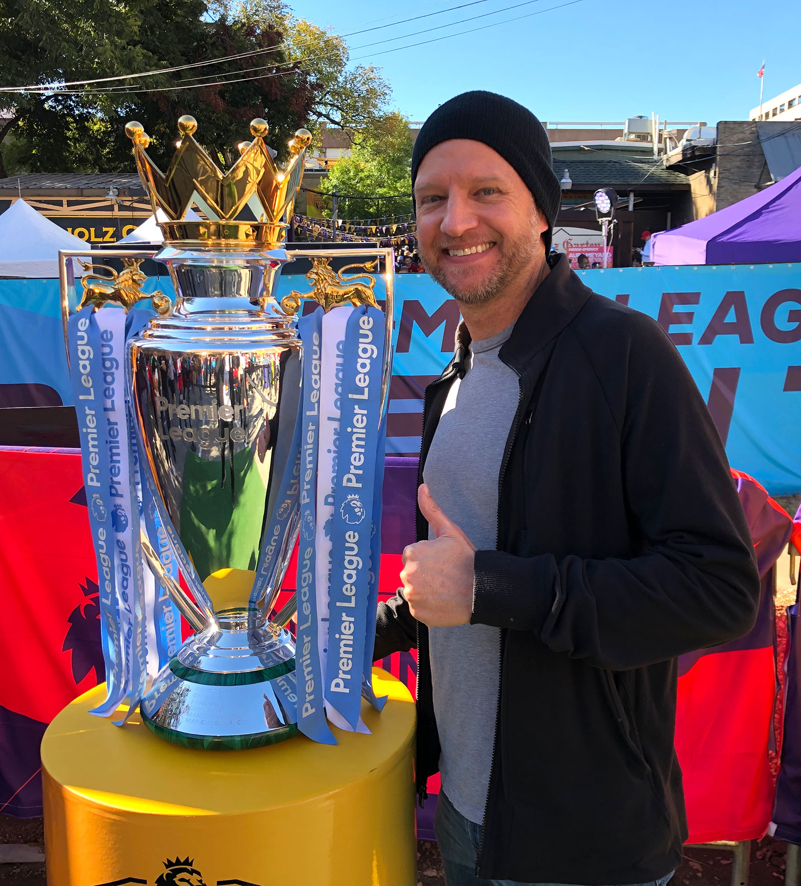 Chris Fig with a large silver trophy.